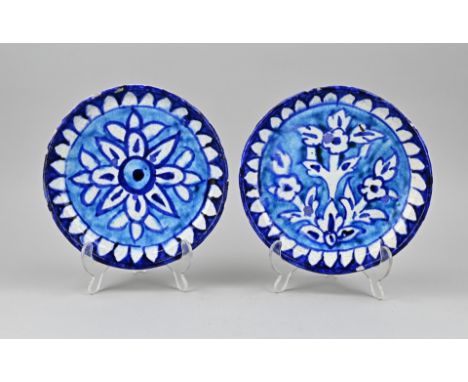 Two antique Persian faience wall plates with floral decoration. Dimensions: Ø 21.5 cm. In good condition.