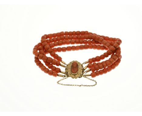 Bracelet of blood corals attached to a yellow gold clasp, 585/000, set with a cameo cut blood coral. The bracelet has 4 rows 