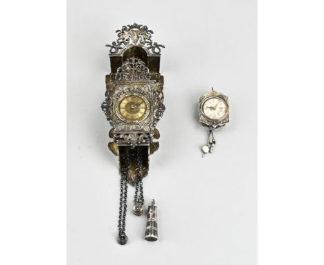 Two silver miniature clocks, 835/000, with a Zaanse clock with vases and a chain with pulley and weight. 19 cm. And a small h