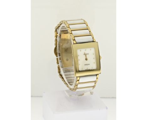 Rado watch, diastar, ladies model with white ceramic. The rectangular case is provided with a mother-of-pearl dial and gold-c