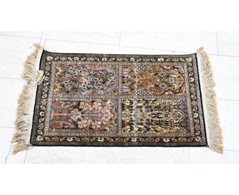 Hand-knotted silk carpet. Persia. Fully decorated with four panels with floral decoration. Dimensions: 97 x 60 cm. In good co