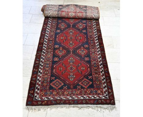 Old Persian runner. Color: red, blue, white/cream etc. 20th century. Dimensions: L 450 x W 107 cm. In good condition.