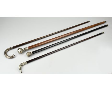 Lot with 4 walking sticks, a wooden walking stick with a plated convex knob, a wooden walking stick with a plated grip in the