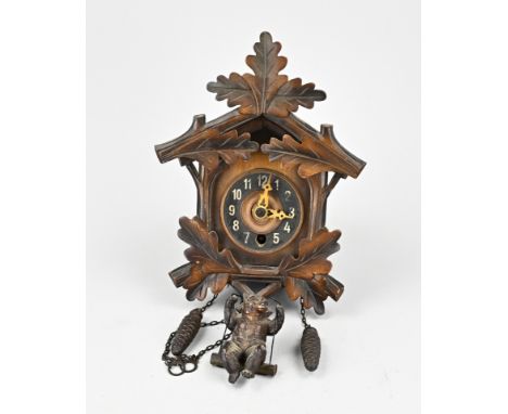Black Forest clock with springy bear as pendulum through winter coat. 20th century. Dimensions: 24 x 17 x 11 cm. In good cond