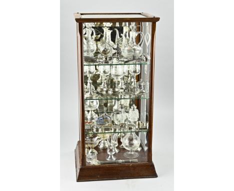 Display cabinet with wood and a mirrored back wall. The cabinet is filled with glassware, 5 glasses with silver base, 2 spice