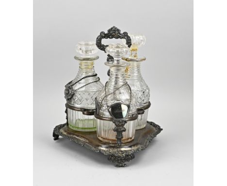 Antique plated liqueur holder with three crystal diamond cut carafes. Circa 1900. One carafe glued. Size: 31 cm. In fair cond