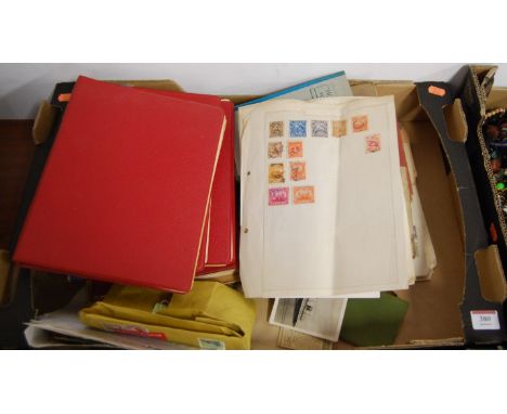 A collection of loose stamps and stamp albums