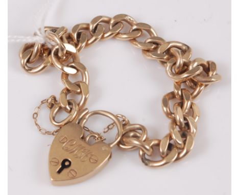 A 9ct gold curblink bracelet with heart shaped padlock clasp and safety chain, 23g.Filed curb links are in good condition.Pad