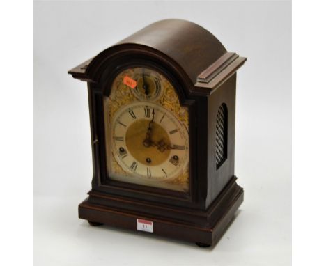 A mahogany cased bracket clock, the silvered arched dial with Arabic numerals within gilt spandrels, having a chime/silent di