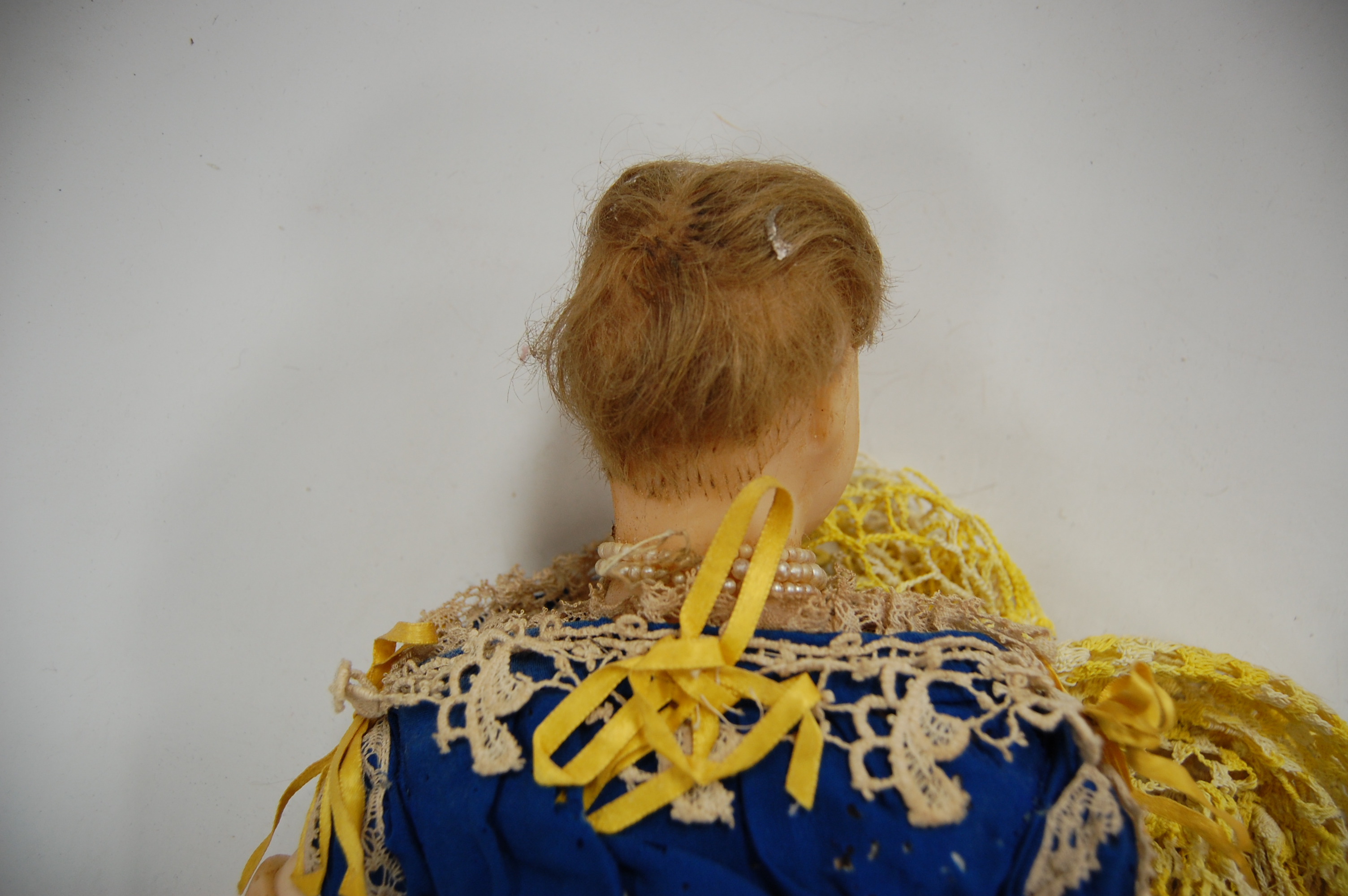 A poured wax head doll having filled body and wax limbs with painted