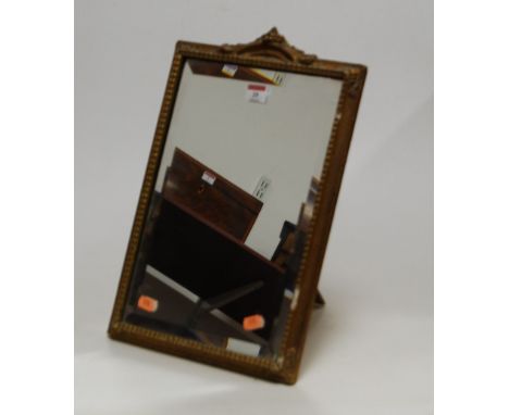 A 1950s easel dressing table mirror, the rectangular bevelled plate within a moulded gilt surround, 44 x 29cm
