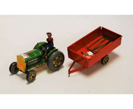 A Mettoy tinplate tractor, with driver and trailer