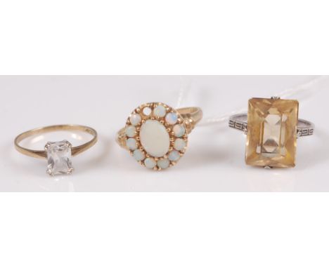 A 9ct gold and cz set dress ring, size M/N; and a 9ct gold cabochon opal set cluster ring (one stone missing), gross weight 5