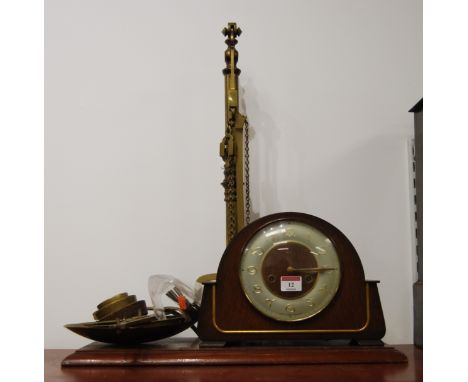 A Victorian brass beam-scale, on mahogany plinth, with various weights; together with a 1950s oak cased mantel clock (2)