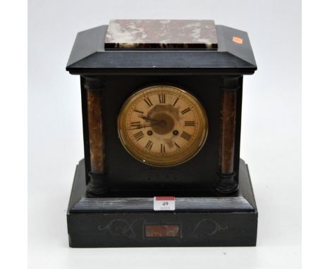 A late Victorian black slate and rouge marble cased mantel clock, of architectural form, having a silvered dial with Roman nu