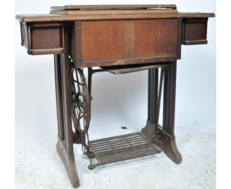 An early 20th century circa 1930’s singer sewing machine table. The table of a rectangular form with metamorphic top, side dr