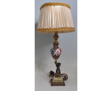 A 20th century brass and enamel table lamp / desk lamp. The lamp having an unusual column decorated with putti to the centre 