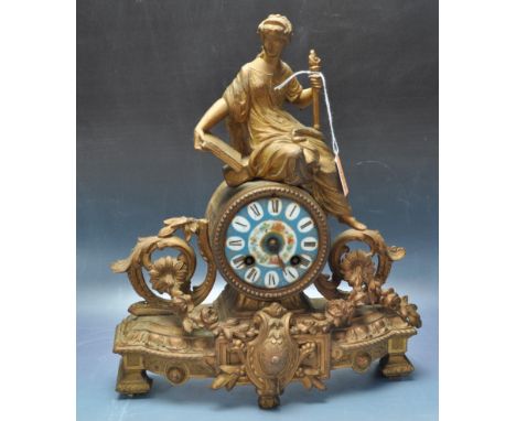 An early 20th century cast metal gilt French 8 day mantel clock. The clock having a blue enamel dial with Roman numerals to t