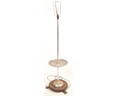 A vintage retro mid 20th century floor standard having tubular column with a circular shelf to the middle raised on a circula