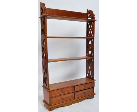 A Victorian style reproduction mahogany / hardwood fret pierced wall mounted spice rack / bookcase. The bookcase of a tall pe
