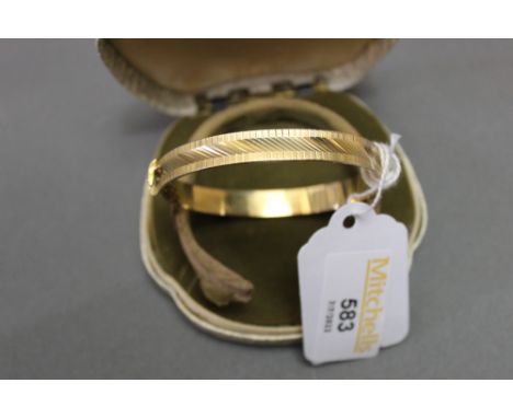 9 ct gold bangle, weight 14.7 grams 