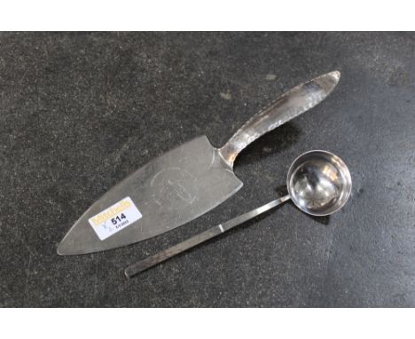 Keswick School of Industrial Art cake slice inscribed Crossthwaite Parish Church Keswick 1181-1981 and a small ladle 17.5 cm 