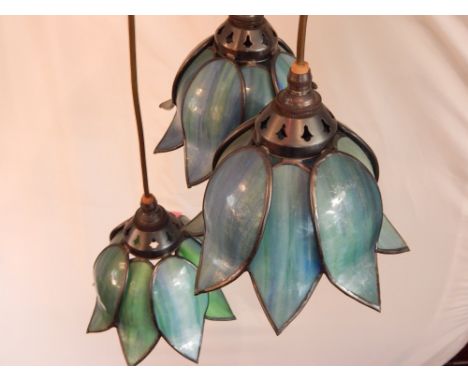 A three branch Tiffany style ceiling light, having coloured leaded glass shades, fashioned as bell flowers.