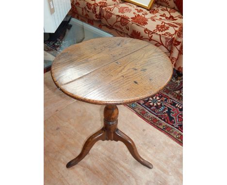 George III oak wine table, the circular top above a baluster support and tripod vase with pad feet, D. 52cm 