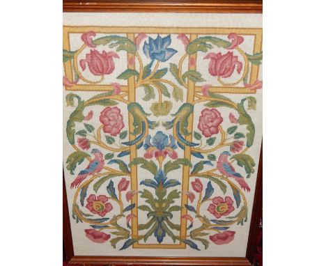 An early 20th century polychrome needlework tapestry, worked with exotic birds amongst flowering branches on a T shaped trell