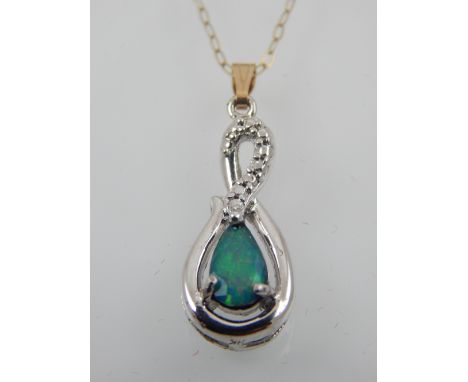 A silver and opal pendant, having 9 carat yellow gold suspension loop and chain. 