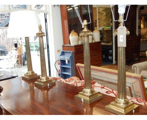 A set of four Victorian style brass Ionic column lamp bases. H. 53cm (4)