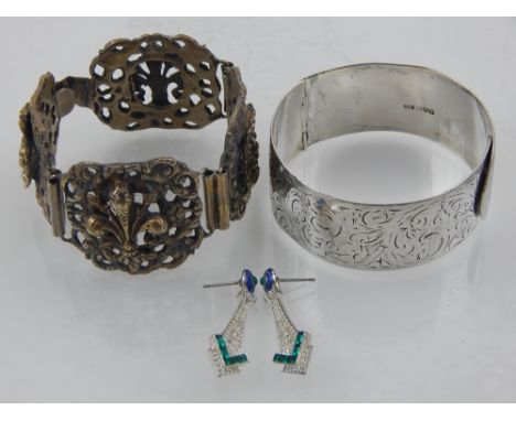 A mid 20th century Charles Horner engraved silver hinged bangle, an eastern white metal four section bracelet, and a pair of 