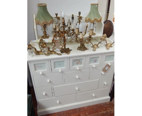 A childs white chest the 3/4 gallery back with pierced heart motif over an arrangement of 13 drawers W 118 cms together with 