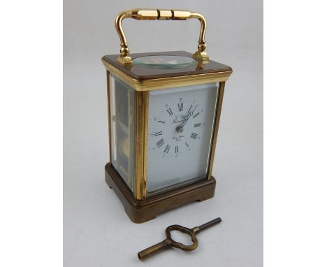 A French brass carriage clock, the white enamel dial with Roman numerals, outer minute track with Arabic markers, Breguet han