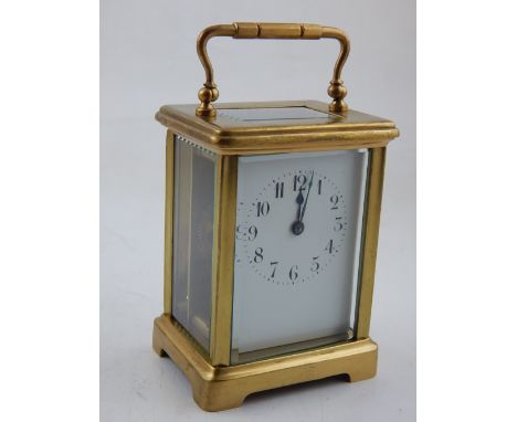 An early 20th century brass carriage timepiece, the white enamel dial with Arabic numerals, spade hands, the door numbered 13