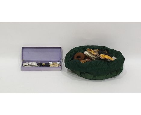Various sewing implements, including vintage thread tools, scissors and other items, all in a green draw string bag