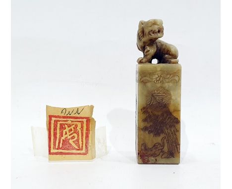 Chinese carved soapstone seal surmounted with a tiger, the square section seal engraved with landscapes and calligraphy, 8.5c