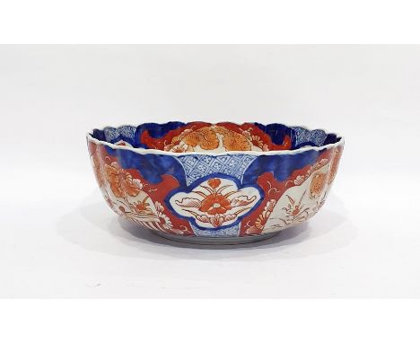 Japanese Imari fluted circular bowl, the interior painted with a jardiniere of flowers on a terrace, the border with cartouch