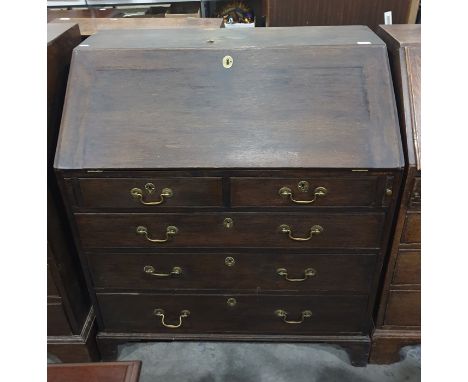 George III oak bureau&nbsp;with sloping fall front fitted interior with cupboard, drawers and pigeonholes, two short and thre