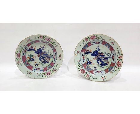 Pair of Chinese porcelain plates, each with lakeside landscape to centre and famille rose type floral borders (2) Condition R