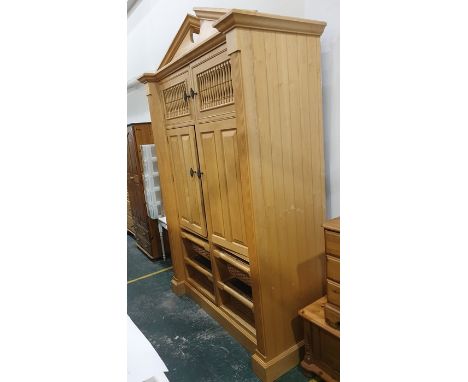 20th century food cupboard with broken arch pediment above two spindle-fronted doors, above two doors enclosing shelves and s