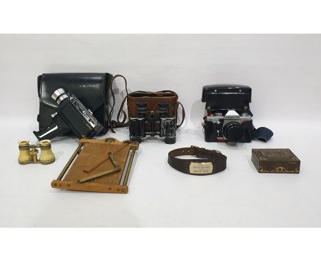 Bell & Howell Auto Load Cine Camera in leather carry case, a pair of binoculars, a Pentagon camera, a Paxette camera, a metal