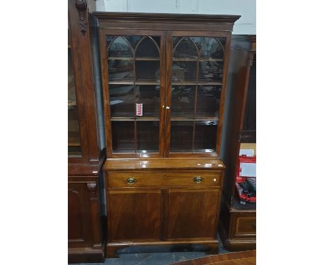 George III style mahogany secretaire bookcase, the ogee pediment above by a pair of astragal glazed panel doors, lancet patte