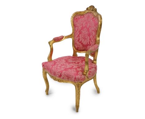 A Louis XV style carved giltwood fauteuil with scroll and flower crest and floral brocade upholstery, 62cm wide, 95cm high  F