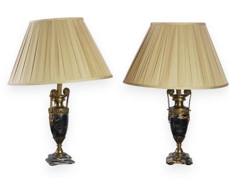 A pair of French Empire style ormolu mounted black marble table lamps decorated with classical motifs, 44cm high Both evenly 