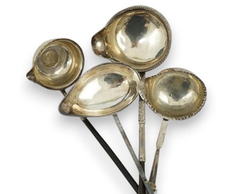A Georgian silver toddy ladle, makers mark stamped four times (rubbed), 43cm and three other unmarked toddy ladles.  All in g