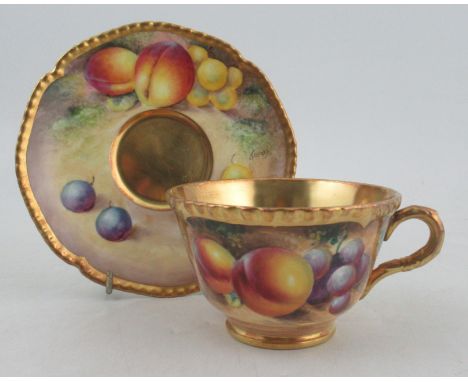 A Royal Worcester tea cup and saucer, the cup decorated with fruit by Roberts, the saucer by TelfordCondition Report:  Good c