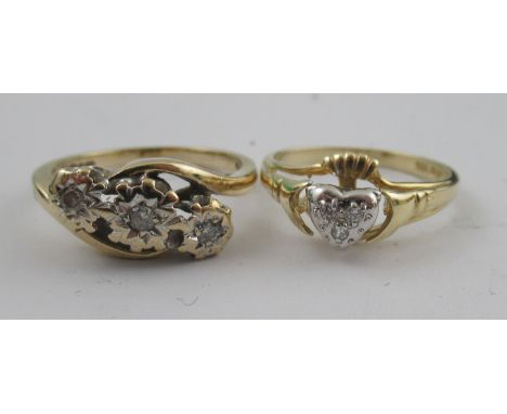 A three stone diamond ring, together with a ring with heart held between hands, stamped 14k&nbsp;