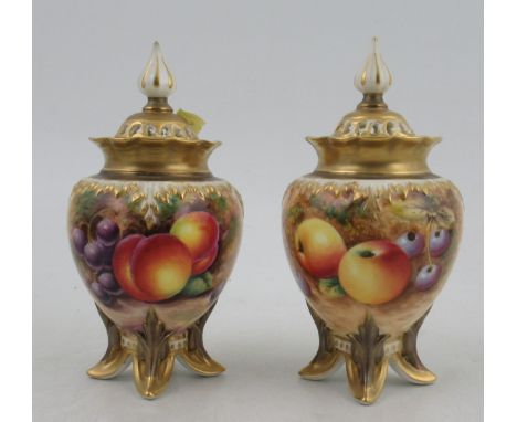 Two Royal Worcester covered vases, painted half round with fruit to a mossy background by R Lewis and Roberts, shape No. H277