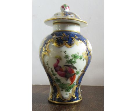 A Worcester style porcelain covered baluster vase, decorated with reserves of insects to a scale blue ground, seal mark to ba